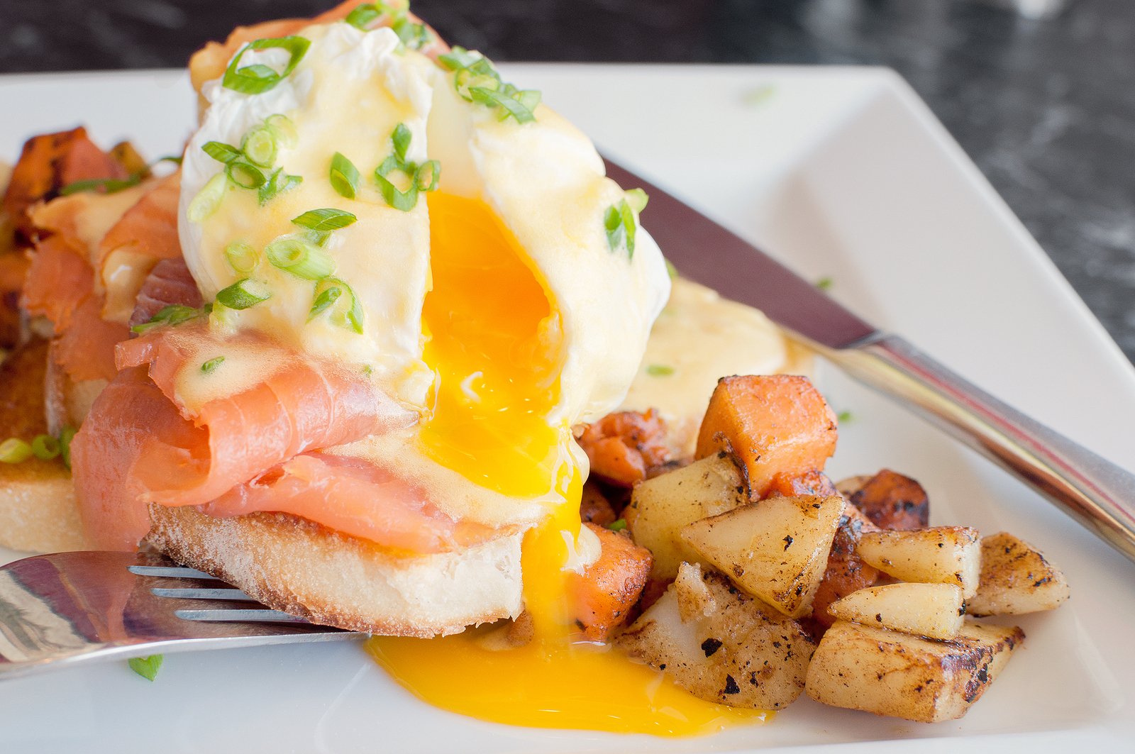 Close up of delicious eggs benedict with runny yellow yolk